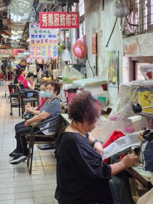 Keelung woman mending clothes in Renai Market